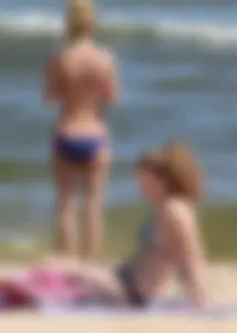 Two sexy beach teens in bikinis, one thick and one skinny with big boobs
