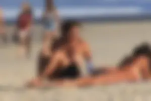 Sexy girls topless on a nude beach showing their nice tits