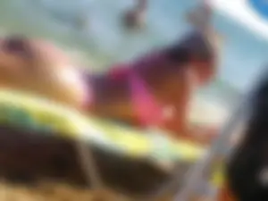 Sexy babe with a nice ass laying in the sun in a pink bikini