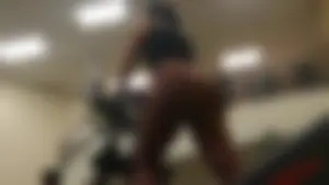 Smoking hot brunette working out at the gym in tight leggings