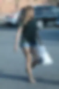 Cutie walking in the parking lot in jean shorts