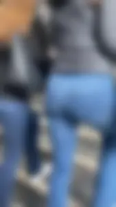 Nice big ass in tight blue jeans walking up stairs and standing in front of me