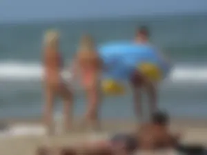Sexy mom and daughter in red thongs at the beach