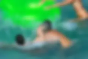 FKK Nudists playing in the water with floater
