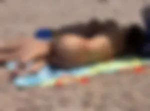 Large collection of hot beach girls lying on the beach and bending over
