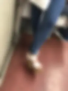Candid girl wearing tight blue jeans and sandals on high platforms