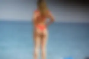 Hot blonde with a slammin body in red thong bikini on the beach