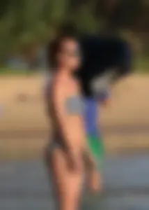 Skinny sexy blonde in little striped bikini in the water