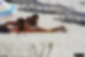 Topless milf and her topless daughter on the beach