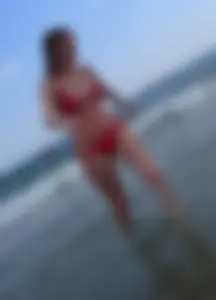 Sexy girl at the beach in a red thong bikini with nice tits and ass