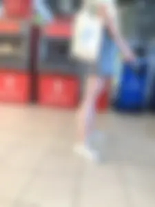 Young Candid Girl With Slim Pale Legs In a Denim Skirt Waiting in the Queue