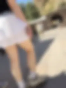 Closeups of a hot girl’s pale legs, she’s wearing a skirt