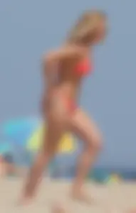 Sexy thick blonde girl with tiny bikini and big booty on the beach