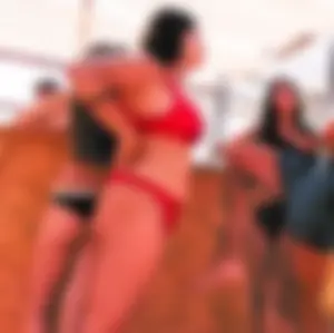 Thick brunette on the beach with friends in red bikini