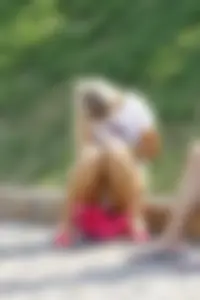 Hot Blonde Sitting on the Border Stone in Shorts - Panties Visible