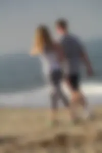 Skinny blonde on the beach in tight grey leggings