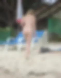 Micro thong blonde on the beach with pokies and camel toe