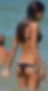 Tight bodied skinny brunette on the beach in a bikini