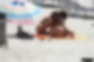 Topless milf and her topless daughter on the beach