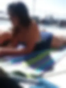 Sexy brunette teen in blue swimsuit by the pool