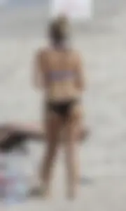 Florida blonde in blue and black bikini on the beach