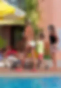 Big boobed blonde milf dancing by the pool in a bikini