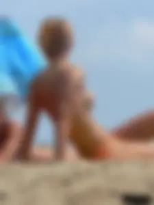 Two topless friends on the beach with nice boobs