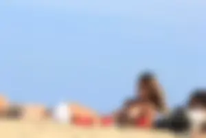Sexy girls topless on a nude beach showing their nice tits