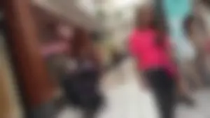 Little blonde teen in grey leggings at the mall with her friends