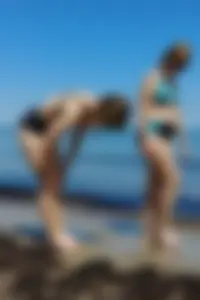 2 sexy friends in bikinis walking on the beach
