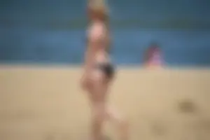 Chunky blonde in a black bikini on the beach