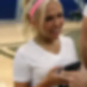 Bunch of cute college girls in bright pink shorts playing volleyball