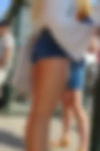 Sexy blonde showing her ass cheeks in short denim shorts and slightly see through shirt