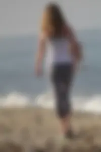 Skinny blonde on the beach in tight grey leggings