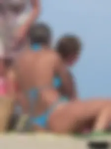 Sexy lady on the beach in a blue thong bikini
