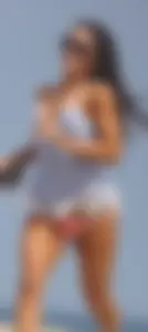 Trio of girls in bikinis on the beach and one with an incredible ass