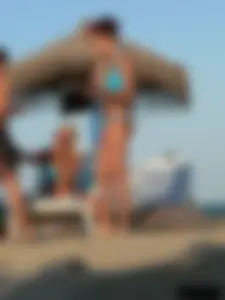 A bunch of hot babes on the beach in thong bikinis