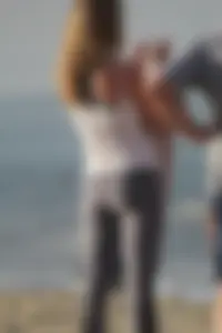 Skinny blonde on the beach in tight grey leggings