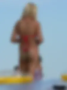 Sexy mom and daughter in red thongs at the beach
