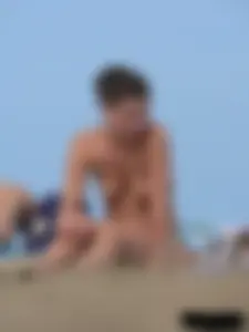 Sexy babe with a nice body topless and in a thong on the beach