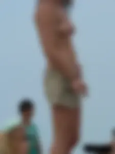 Sexy babe with a nice body topless and in a thong on the beach