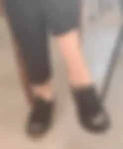 Teen college girl's ankles and feet in shoes closeups (sitting with her legs crossed)