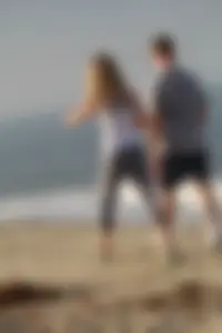 Skinny blonde on the beach in tight grey leggings