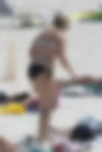 Big boobed thick blonde on the beach in a bikini