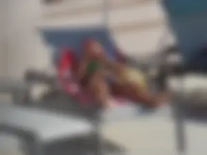 Hot milf sunbathing in a thong by pool and swimming