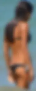 Tight bodied skinny brunette on the beach in a bikini