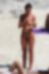 Smoking milf at a nude beach with a hairy pussy