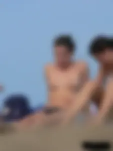 Sexy babe with a nice body topless and in a thong on the beach