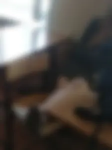 Candid College Girl in a Skirt Sitting On Two Chairs With Crossed Legs in Classroom