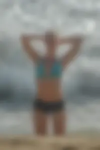 Blonde lady on the beach in bikini top and spandex shorts with a nice gap